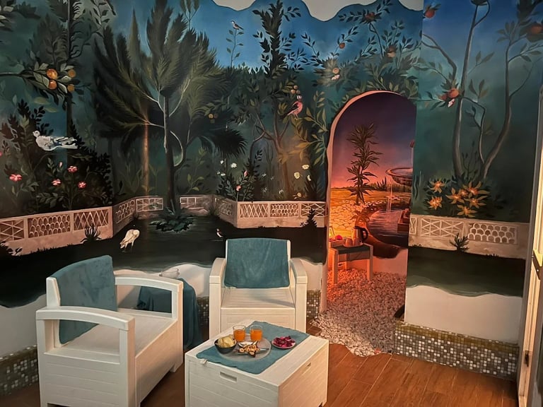 Luxury tropical resort lounge with painted jungle mural, white furniture, fire pit, and sunset archway entrance