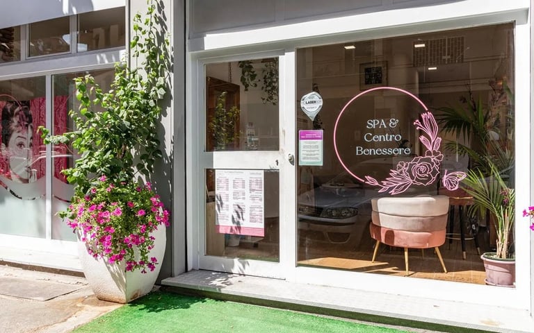 Spa and beauty center storefront with pink neon signage, flowering plant display, and modern interior visible through glass windows